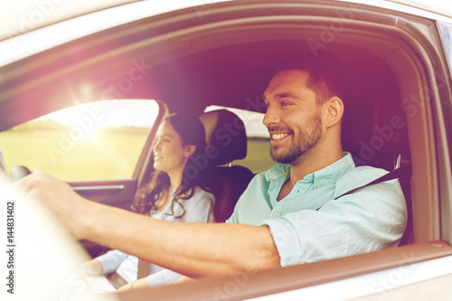 Fotomural happy man and woman driving in car