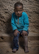 © ADDICTIVE STOCK - Sad little boy sitting at the wall