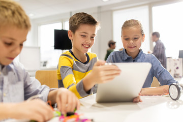 Wall Mural - kids with tablet pc programming at robotics school