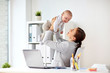 © Syda Productions - happy businesswoman with baby and laptop at office