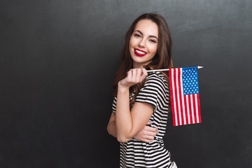 Canvas Print - Side view of woman holding USA flag