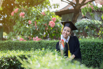 Happy Graduate celebrating with certificate in her hand and feeling so happiness in Commencement day