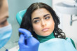 © DenisProduction.com - Woman at the stomatologist. Young female with serious face. Trust health problems to professionals.