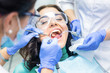 © DenisProduction.com - Two dentists busy with patient. Person in dental safety glasses.