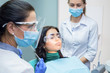 © DenisProduction.com - Dentists working at the office. Patient wearing dental safety glasses.
