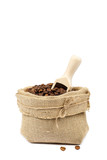 Fototapeta Storczyk - Coffee beans in canvas bag with wooden scoop
