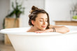 © rh2010 - Beautiful young woman relaxing lying in the bathtube in the bathroom