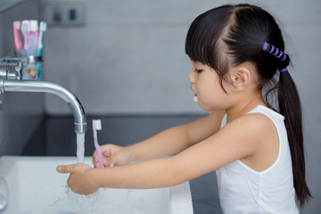 Wall Mural - Little asian cute girl brush teeth