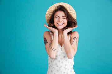 Portrait of a cheerful smiling girl in straw hat