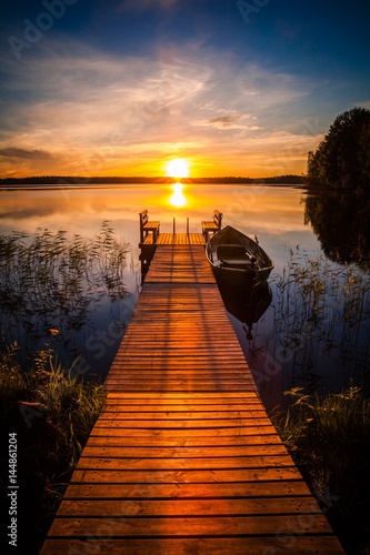 Cuadros en Lienzo Sunset over the fishing pier at the lake in Finland