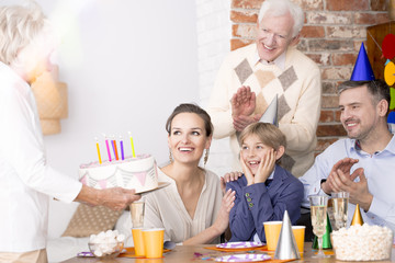 Wall Mural - Grandmother holding birthday cake