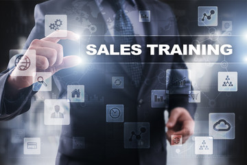 Wall Mural - businessman selecting sales training on virtual screen.