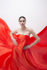 Wall Mural - Young woman dressed in orange fabric