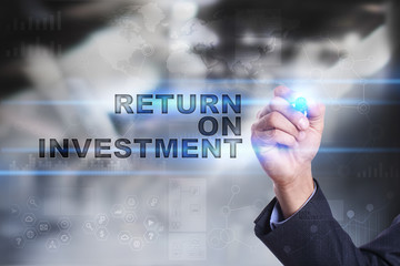 Businessman is drawing on virtual screen. return on investment concept.