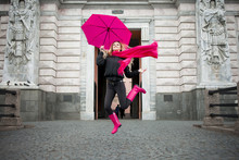 Beautiful Young And Happy Blond Woman With Colorful Umbrella On The Street. The Concept Of Positivity And Optimism
