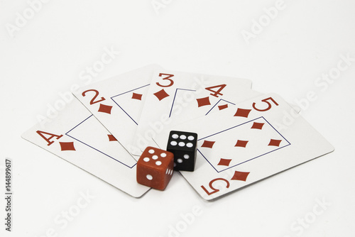 фотография Red and white playing cards and a pair of black and red dice on a white background
