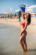 © Aleksandr - Beautiful girl in a pink bathing suit, in the sea. Sunny weather. Summe