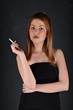 © muro - young woman with cigarette, smoking concept on black background
