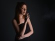 © muro - young woman with cigarette, smoking concept on black background