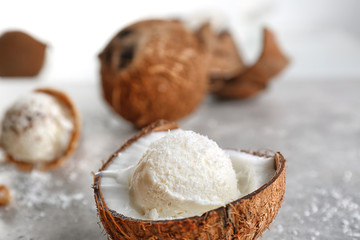 Wall Mural - Fresh ball of ice cream in half of coconut on kitchen table