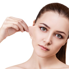 Woman remove her old dry skin from face.