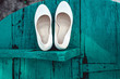 © Mykola - bride's biege shoes on heel on a wooden board tiffany colour