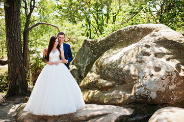 Lovely wedding couple at amazing landscapes with rock Dovbush, Carpathian mountains at Ukraine.