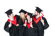 © LIGHTFIELD STUDIOS - Happy students in academic caps standing embracing with diplomas