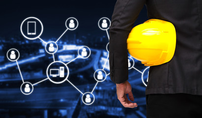 back view of smart businessman in black suit with yellow safety helmet with icon social media concep