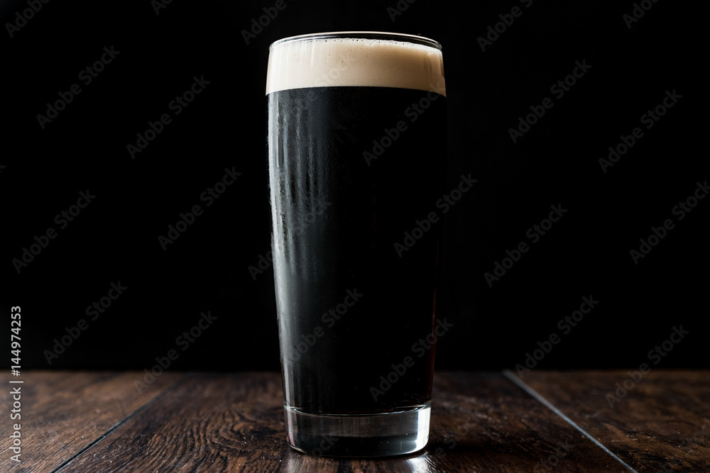 Dark beer on wooden surface. copy space. - obrazy, fototapety, plakaty 