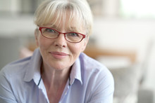 Portrait Of Senior Woman With Red Eyeglasses On