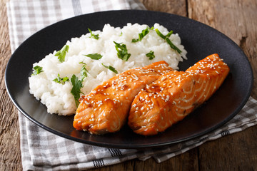 Wall Mural - Fried salmon in a honey-soy glaze and rice close-up. horizontal