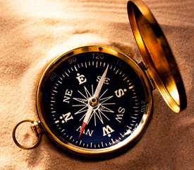 Wall Mural - Golden compass with beach sand
