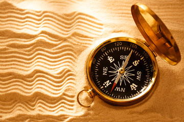 Wall Mural - Golden compass with beach sand