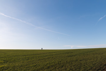 Lone Person Standing In An Empty Field