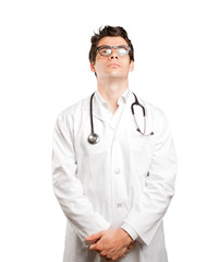 Satisfied doctor looking against white background