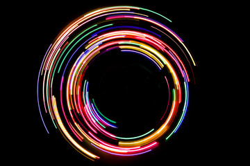 abstract rotating neon lights texture with black empty copy space inside.