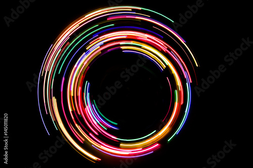 Fotografie, Obraz Abstract rotating neon lights texture with black empty copy space inside