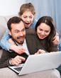 © JackF - Family booking hotel online on laptop