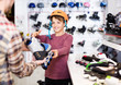 © JackF - Male shop assistant helping boy to choose roller-skates in sports store