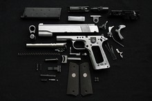 Disassembled Handgun On Black Background,