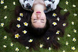 Leinwandbild Motiv Asian beautiful young woman lying on lawn with flowers
