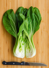 Bok choy with  knife on wooden background. Pak choy is a type of Chinese cabbage(Qing geng cai )and one of the healthiest vegetable and popular superfood.