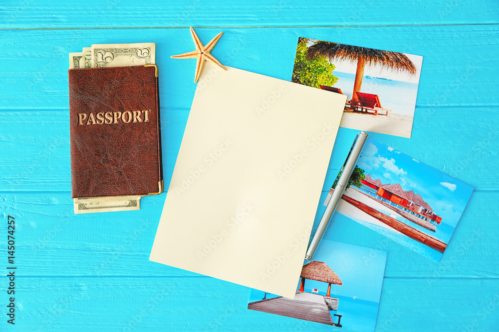 Travel concept. Passport, blank notepad page and pen on wooden background