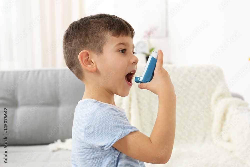 Little boy using asthma inhaler at home - obrazy, fototapety, plakaty 