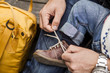 © Astrakan Images - Cropped image of father tying shoelace of baby girl at park