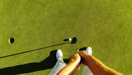 Sticker - Golf player at the putting green hitting ball into a hole