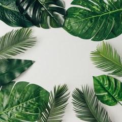 Creative nature layout made of tropical leaves and flowers. Flat lay. Summer concept.