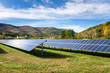 Solar Power Plant in Mountain Landscape under Blue Sky with Clouds. 