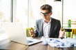 © F8  \ Suport Ukraine - Frustrated business man on desk with paper and laptop being stressed angry